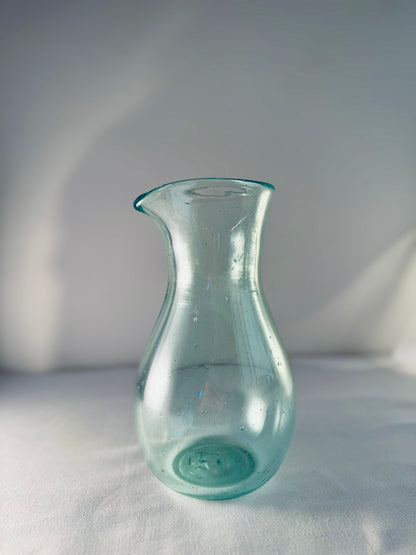 Enyo Living Germany Ocean Green glass carafe with a pouring spout and bulbous base.