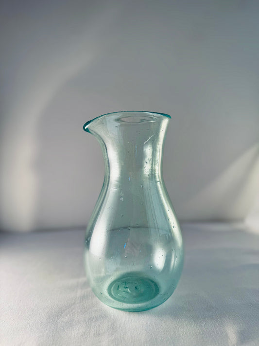 Enyo Living Germany Ocean Green glass carafe with a pouring spout and bulbous base.