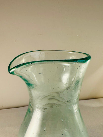 Enyo Living Ocean Green glass carafe with a pouring spout and subtle air bubbles.
